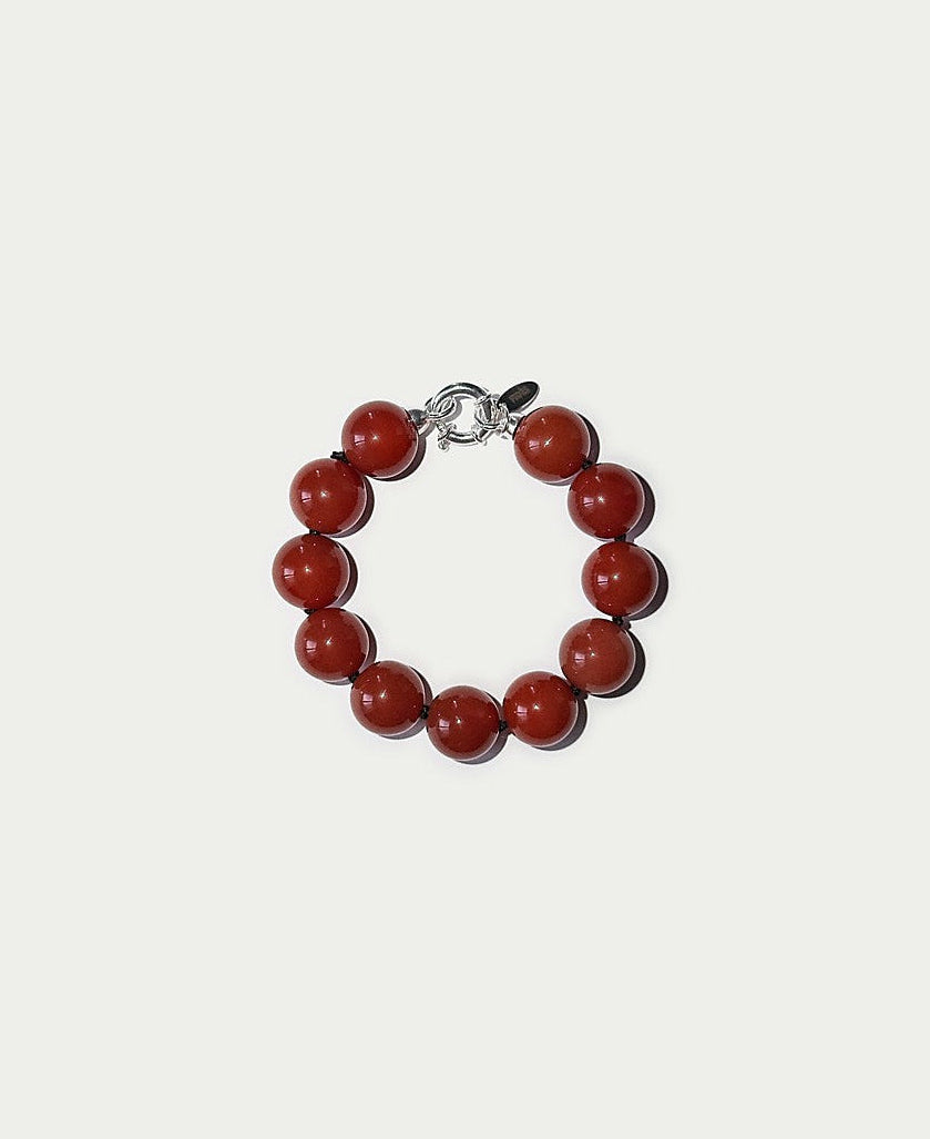 Bracelet with red beads on a white background