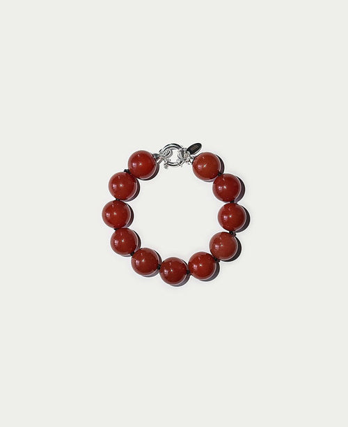 Bracelet with red beads on a white background